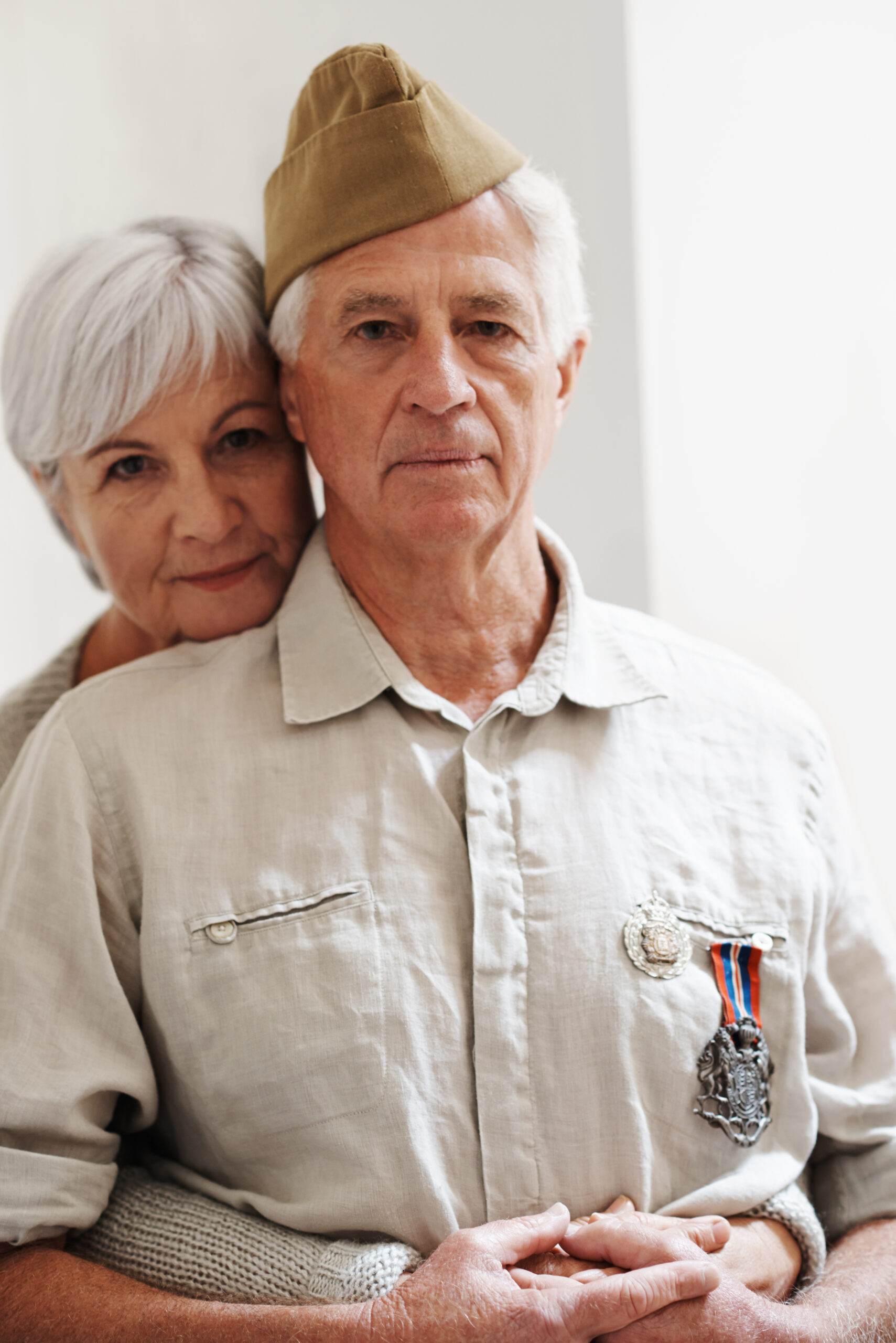 A veteran being hugged by a loved one. 