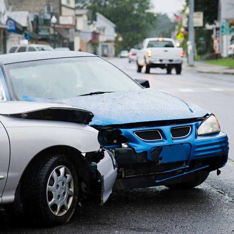 Car crash with two vehicles collided at traffic accident site on street.